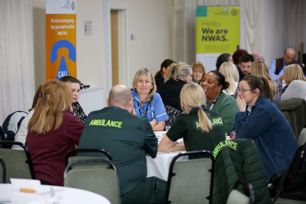 close up of people sat round a table having a discussion