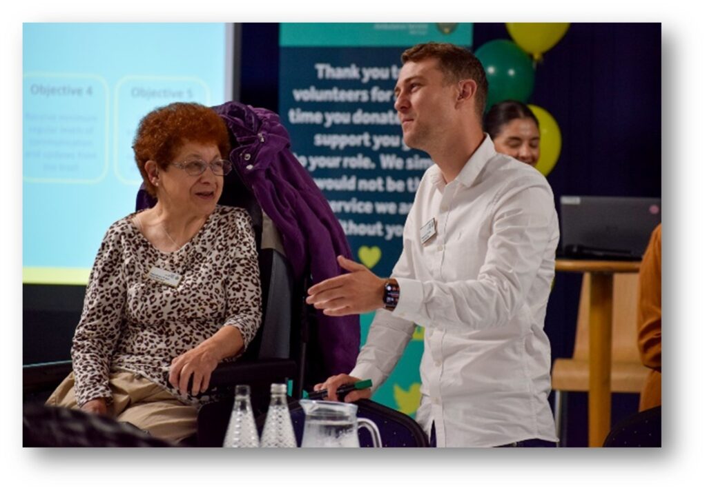 Patient and public panel members talking at an event