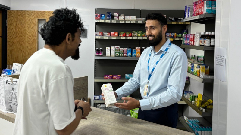 person speaking to a pharmacist