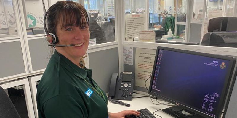 Woman with headset at a desk. Emergency Medical Advisor