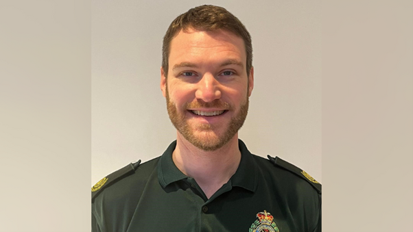 Image of a man with light brown hair and a beard smiling.