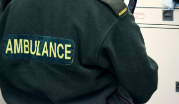 back of a green uniform with the word 'ambulance'