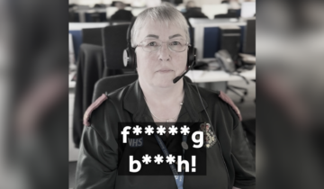 A lady with short hair and glasses, wearing a green uniform and a headset. The subtitles on the image display 'f*****g b***h!'